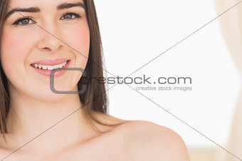 Smiling nude girl looking at camera