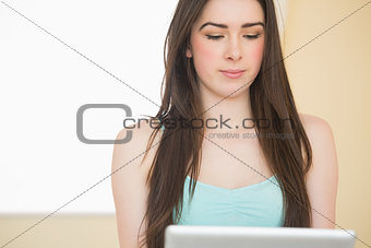 Thoughtful girl using a tablet pc