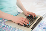 Close up of a girl typing on a laptop