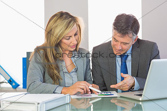 Two content business people trying to understand figures