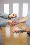 Close up of a handshake and a key delivery