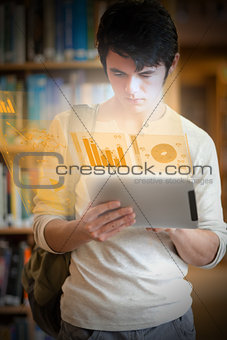 Serious handsome student working on his futuristic tablet