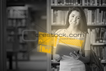 Cheerful cute student working on her futuristic tablet pc