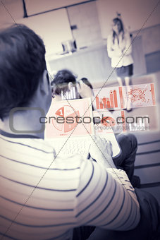 Concentrated student analysing graphs on his futuristic notebook
