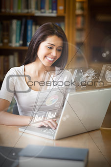 Smiling student analysing graphs on her digital laptop