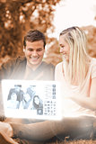 Happy young couple watching photos on digital interface