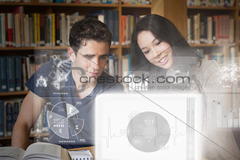 Smiling college friends studying on digital interface