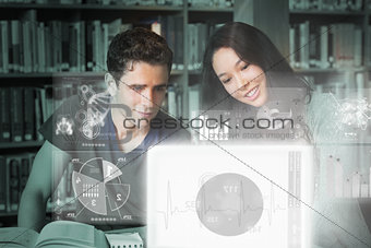 Cheerful college friends studying on digital interface
