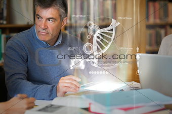 Mature student using futuristic hologram to learn biology from tablet pc