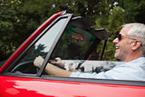 Smiling handsome man driving red convertible