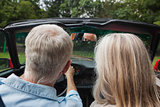 Rear view of mature couple going for a ride together