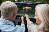 Rear view of smiling mature couple going for a ride together