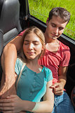 Overhead of cute couple relaxing in their cabriolet