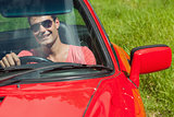 Smiling handsome man driving his cabriolet