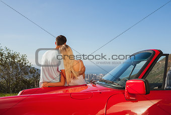 Rear view of couple hugging and admiring panorama
