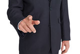Businessman pointing finger at camera