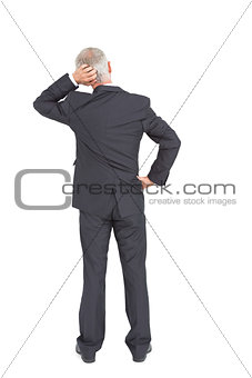 Rear view of doubtful mature businessman