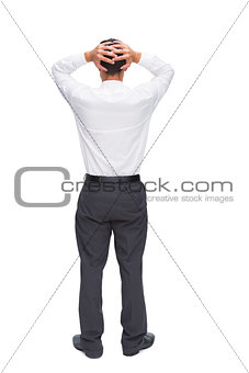 Businessman standing back to camera hands on head