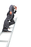 Low angle view of businessman standing on ladder