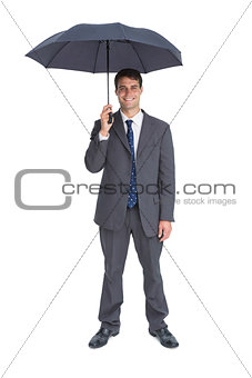 Happy businessman holding grey umbrella