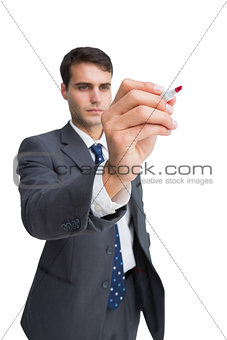 Concentrated businessman holding red marker