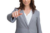 Smiling businesswoman pointing at screen