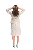 Businesswoman with hands on head standing back to camera