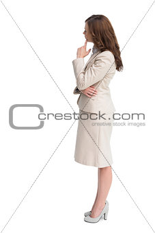 Profile view of doubtful businesswoman standing