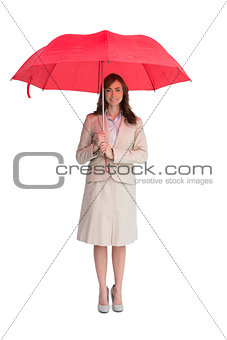 Attractive businesswoman holding red umbrella