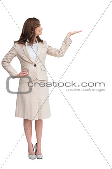 Smiling businesswoman raising her hand