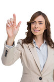 Young businesswoman touching invisible screen