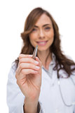 Smiling doctor holding pen