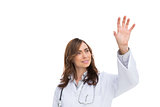 Brunette doctor reaching for something in the air