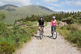 Athletic couple cycling through countryside
