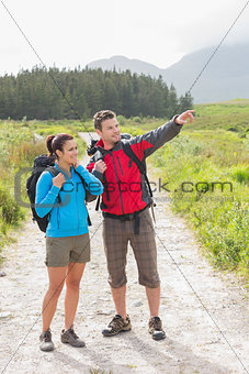 Hikers with backpacks standing on country trail