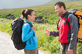 Hikers with backpacks chatting together