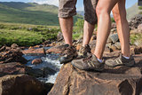 Couples feet standing at edge of river