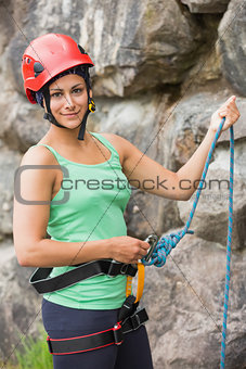 Pretty rock climber about to start her climb