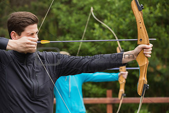 Handsome man practicing archery