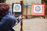 Brunette about to shoot arrow