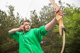 Concentrating man practicing archery