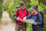 Couple going on a hike together looking at map
