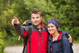 Smiling couple going on a hike together looking ahead