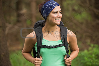 Happy woman standing in a forest