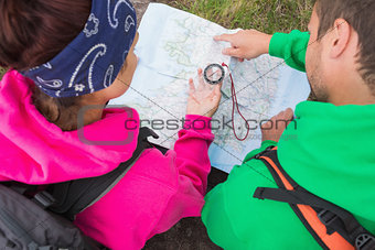 Couple using compass and map