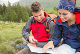 Couple using map and compass to find the way