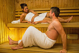 Calm couple relaxing in a sauna and chatting