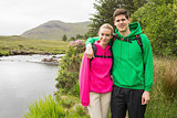Athletic couple in hooded jumpers on a hike