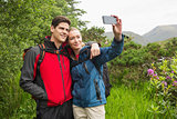 Happy couple on a hike taking a selfie
