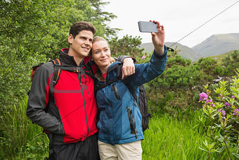 Happy couple on a hike taking a selfie